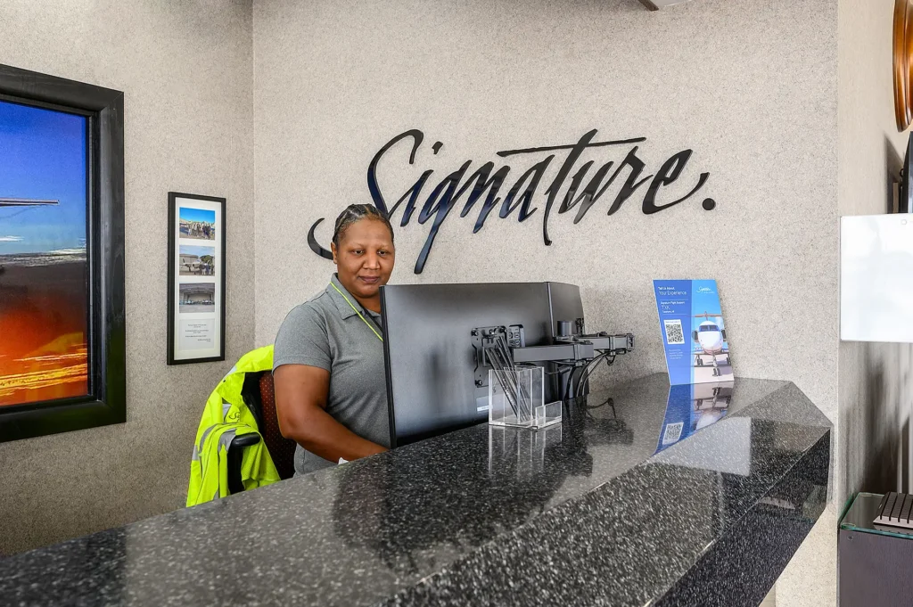 Signature Aviation employee working the front desk at TXK airport