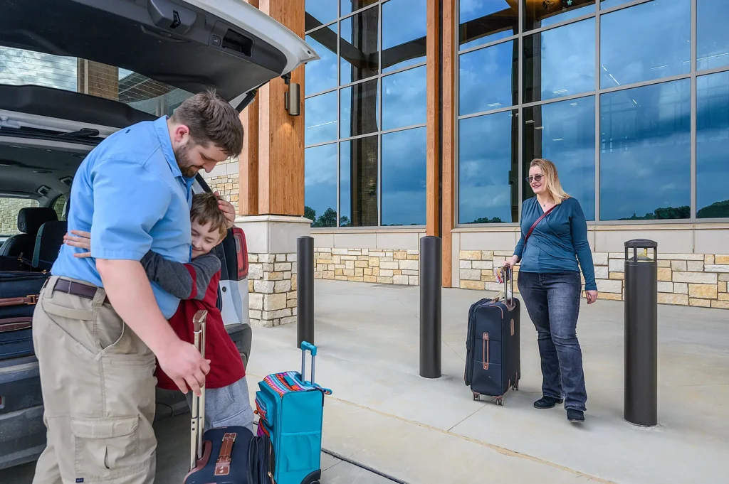 A family being dropped off at the curb of the new Texarkana Regional Airport terminal