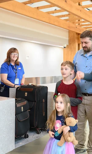 A family checking in luggage at the Texarkana Regional Airport ticket counters